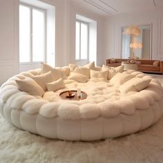 a living room filled with lots of white furniture