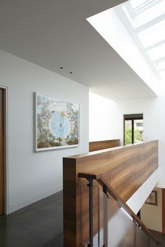 the stairs are made of wood and have skylights above them in this modern home