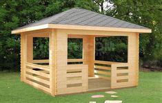 a small wooden gazebo sitting on top of a green grass covered field next to trees