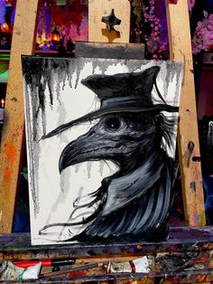 a painting of a crow wearing a hat on top of a easel in front of flowers