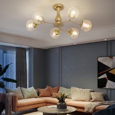 a living room with couches, tables and lamps on the ceiling in front of a large window