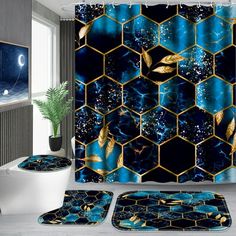 a bathroom with a blue and gold shower curtain, rugs and bath mats in the shape of hexagon tiles