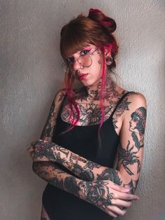 a woman with red hair and tattoos on her body