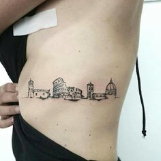 a woman's stomach with a small tattoo of buildings on the side of her body