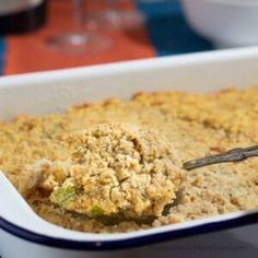 a casserole dish is filled with food and has a spoon sticking out of it