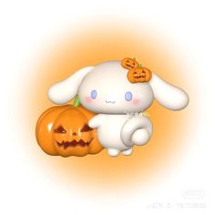 a white bunny holding a jack - o - lantern