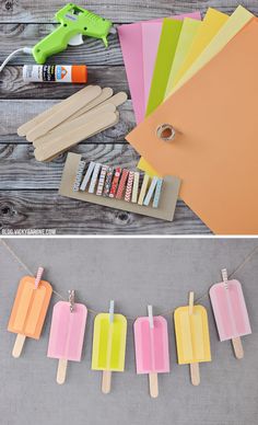 popsicles and glue are on the clothes line next to some crafting supplies