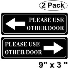 two black and white signs with arrows pointing in different directions, one for each other