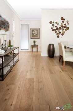 a living room filled with furniture and a wooden floor covered in hard wood planks