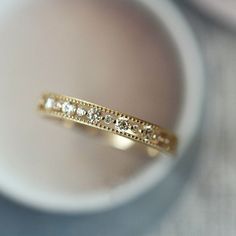 a close up of a gold ring with diamonds