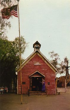 an old red brick building with a flag on top