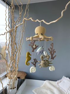 an octopus mobile hanging from the ceiling next to a window