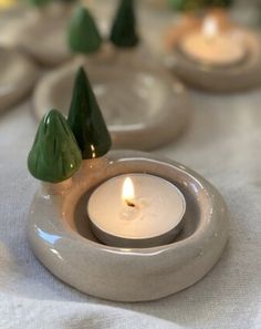 small white candles sitting on top of a table