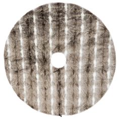 a round rug with white and grey stripes on the bottom, it has a circular hole in the middle