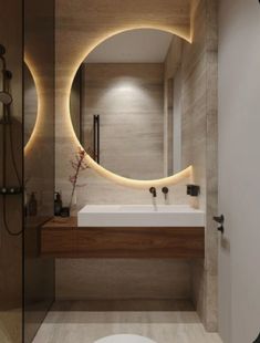 a bathroom with a round mirror above the sink