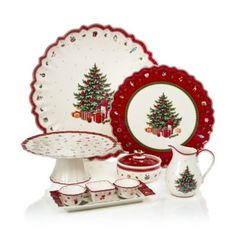 a christmas dinner set with red and white plates, cups, and saucers in the shape of a tree