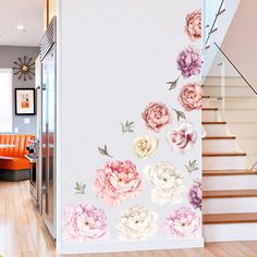 this is an image of a staircase with flowers on the wall and stairs in the background