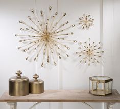 a table topped with two jars and a starburst wall decoration