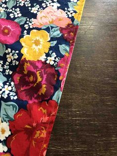 an image of a flowered table runner on a wooden surface with the fabric pulled down