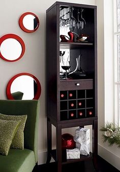 a living room with a green chair and wine rack