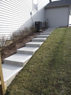 concrete steps leading up to the side of a house