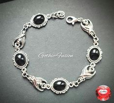 Hello, today I have for you a black version of my victorian gothic vampire bat bracelet. Ornate link bracelet embellished with black onyx and clear crystals for a touch of sparkle. Small extender chain added to each bracelet for adjustment if needed. Please measure your wrist carefully before ordering to ensure a good fit. Thank you for looking. Any questions please ask before purchasing. Please note my work is costume jewellery and made with mixed base and alloy metals NOT precious metals unless otherwise stated. All of my work is handmade personally and made with love, not mass produced in factories. I only design and makes pieces I love and wear myself. Victorian Gothic Vampire, Bat Bracelet, Vampire Bride, Bat Jewelry, Gothic Bracelet, Gothic Vampire, Vampire Bat, Goth Jewelry, Gothic Wedding