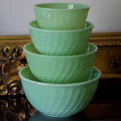 four green bowls stacked on top of each other