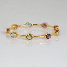 Multi Gemstone Bangle, 925 Sterling Silver, Amethyst, Blue Topaz, Peridot Bangle, Gold Plated Bangle, Gemstone Bangle, Handmade Designer. Manufacture Country : India * Customization always available for Ring size, metal selection and any type of center stones changes, etc.... * If you want to make your own idea of Jewelry we can do it. Material : 925 Sterling Silver Main Stone : Amethyst Secondary Gemstone : Blue Topaz, Peridot,  Gemstone Color :  Gemstone Shape : As Seen In A Picture Bracelet Width : 2.4 Inc Weight : 22.32 gm * Shipment will dispatch within maximum 2-3 Days of Order done * Some Special customization can take more Time * UPS, DHL, FEDEX OR ARAMEX Will be available for Delivery Cheap Bangle With Faceted Beads, Luxury Stone Bangle, Luxury Gemstone Accented Bangle Bracelet, Luxury Gemstone Bangle Jewelry, Luxury Gemstone Bangle, Luxury Gold Bangle With Gemstone Accents, Luxury Gemstone Engagement Bangle, Cheap Faceted Beads Bangle Jewelry, Luxury Bangle With Gemstone Accents