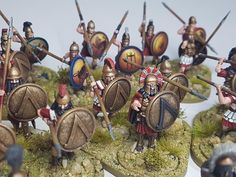 a group of toy soldiers with spears and shields