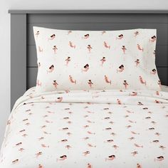 a white bed with pink flamingos on it