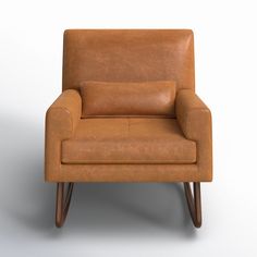 a brown leather chair sitting on top of a white floor