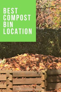 a pile of leaves sitting on top of a wooden crate next to a green sign that says best compost bin location