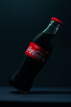 a coca cola bottle sitting on top of a table