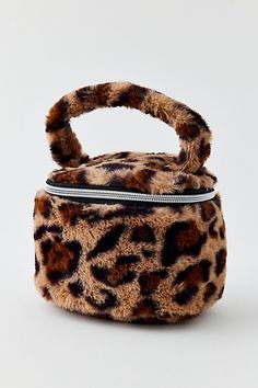 A bold take on your travel essentials, this textural makeup bag features a fuzzy exterior lined with an oversized handle for easy carrying. This spacious makeup bag offers a spacious interior to store your makeup, skincare regimen and other beauty products. Features Fuzzy Makeup Bag Textural makeup bag Handled design for easy carrying Zip closure Perfect for gifting Content + Care 100% Polyester Spot clean Imported Size Dimensions: 4.7" l x 4.7" w x 6.3" h Weight: 0.13 lbs | Fuzzy Makeup Bag in Leopard Makeup, Skincare Regimen, Birthday Idea, Brand Sale, Beauty Wellness, Makeup Skincare, Bag Handle, Skin Care Regimen, Travel Essentials