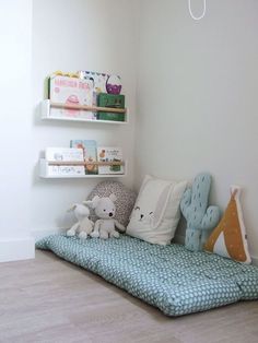 a child's room with bookshelves and stuffed animals