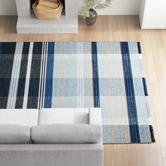 an overhead view of a living room with couches and rugs