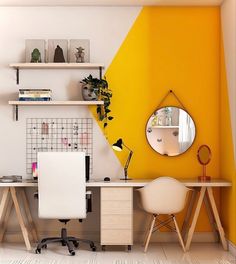 an office with two desks and a mirror on the wall, in front of a yellow accent wall