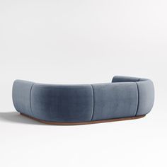 a blue couch sitting on top of a white floor