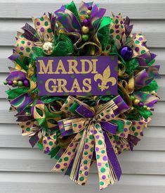 a wreath with mardi gras decorations on it