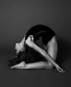 a woman is doing a handstand on the floor