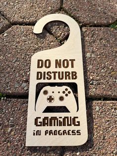 a wooden sign that says do not disturb gaming in languages