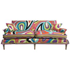 a colorful couch sitting on top of a white floor