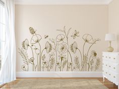 a wall with flowers and butterflies painted on it in a room next to a window