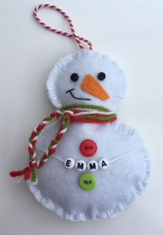 a snowman ornament hanging from a string