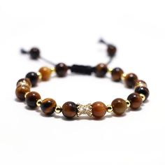 PRICES MAY VARY. Natural: This tiger's Eye stone bracelet is handmade with authentic natural gemstone beads of high quality, with adjustable rope woven by hand, odorless, lead-free, nickel-free and durable Healing gemstone: Tiger's Eye represents courage, strength and determination, can stimulate people's potential, help improve self-confidence and action, in addition to Tiger's eye is also regarded as a healing gem, can reduce physical pain and discomfort. Size and packaging: Beads are approximately 8mm in diameter, the bracelet has an adjustable inner diameter of 7 to 9.5 inches and is packaged in a high-end 3D levitating jewelry case Best gift: This exquisite bracelet is wrapped in a high-end 3D floating jewelry case, making it a great gift for him/her Guarantee: HANDFCJH JL provides yo Floating Jewelry, Cat Eye Bracelet, Physical Pain, Beads Bracelets, Crystal Healing Bracelets, Eye Beads, Chakra Bracelet, Gemstone Beaded Bracelets, Eye Bracelet