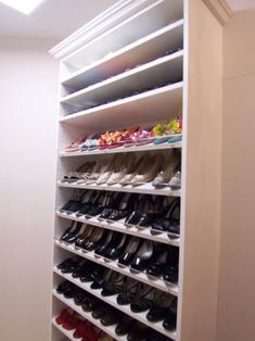 a closet filled with lots of shoes next to a wall mounted shelf full of pairs of shoes