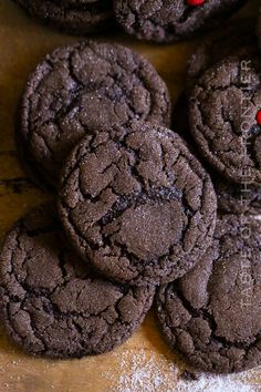 chocolate cookies with red candies are on a table