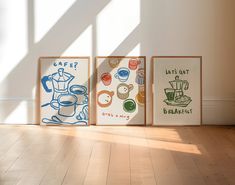 three framed art prints sitting on top of a wooden floor