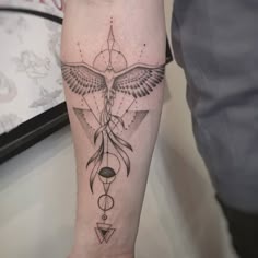 a person with a bird tattoo on their arm