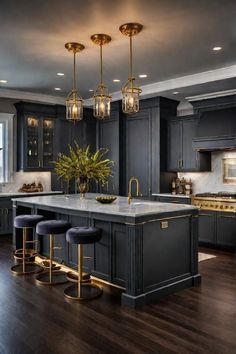 a large kitchen with black cabinets and gold accents